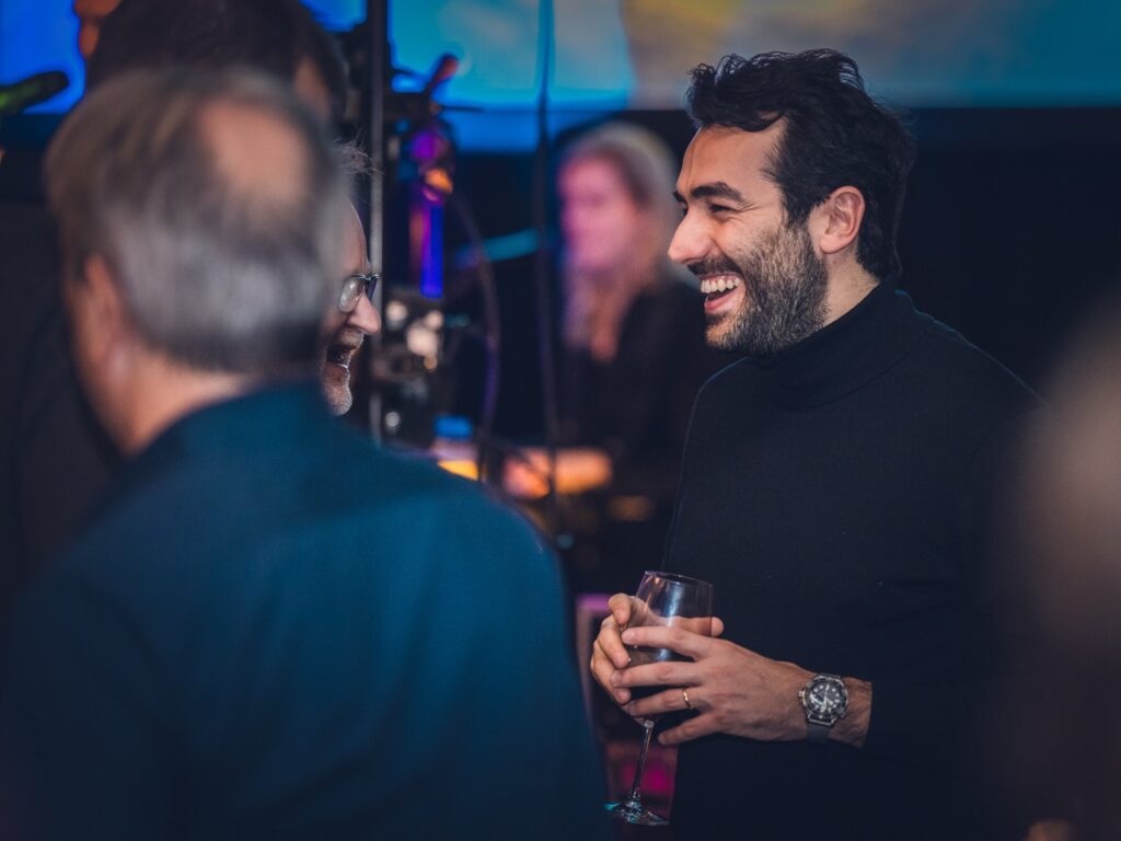 Guests laughing together at the Festive Evening
